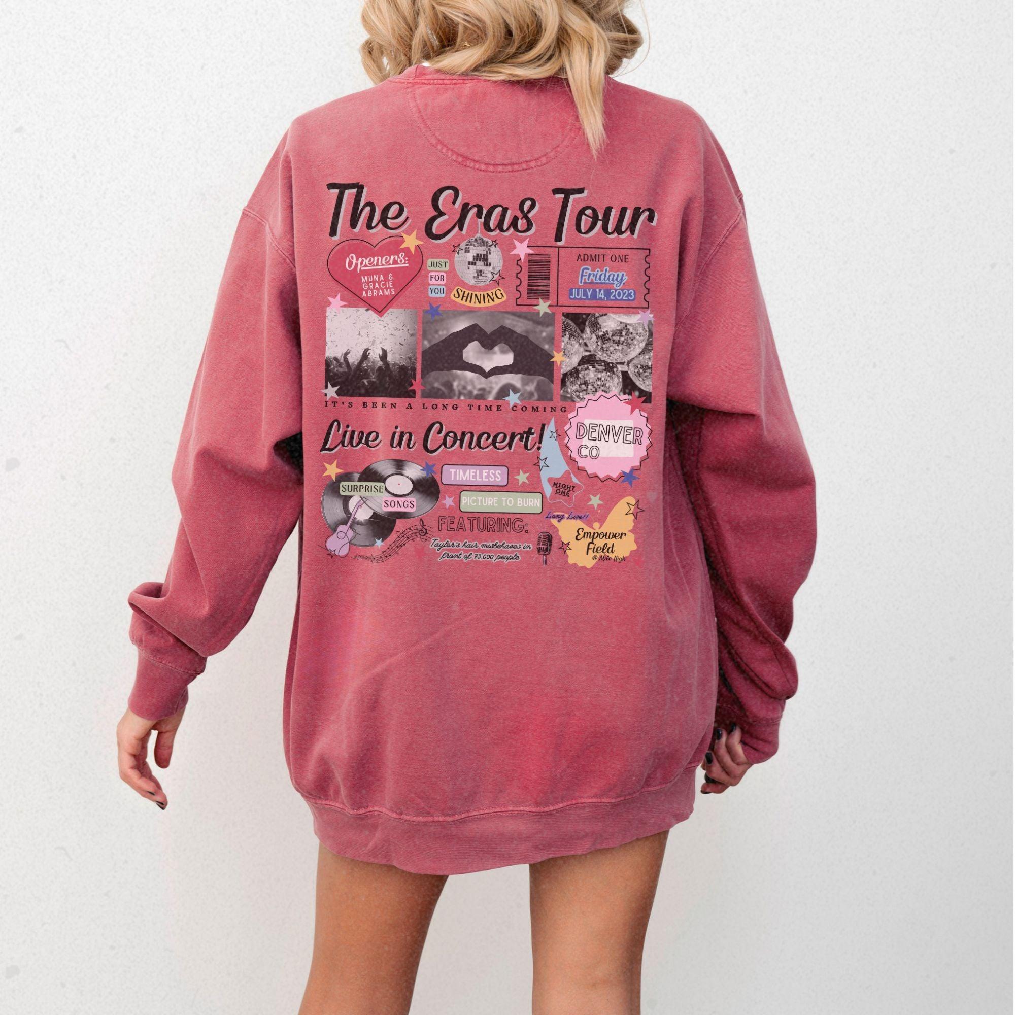 a woman is wearing a pink sweatshirt with pictures on it