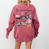 a woman is wearing a pink sweatshirt with pictures on it
