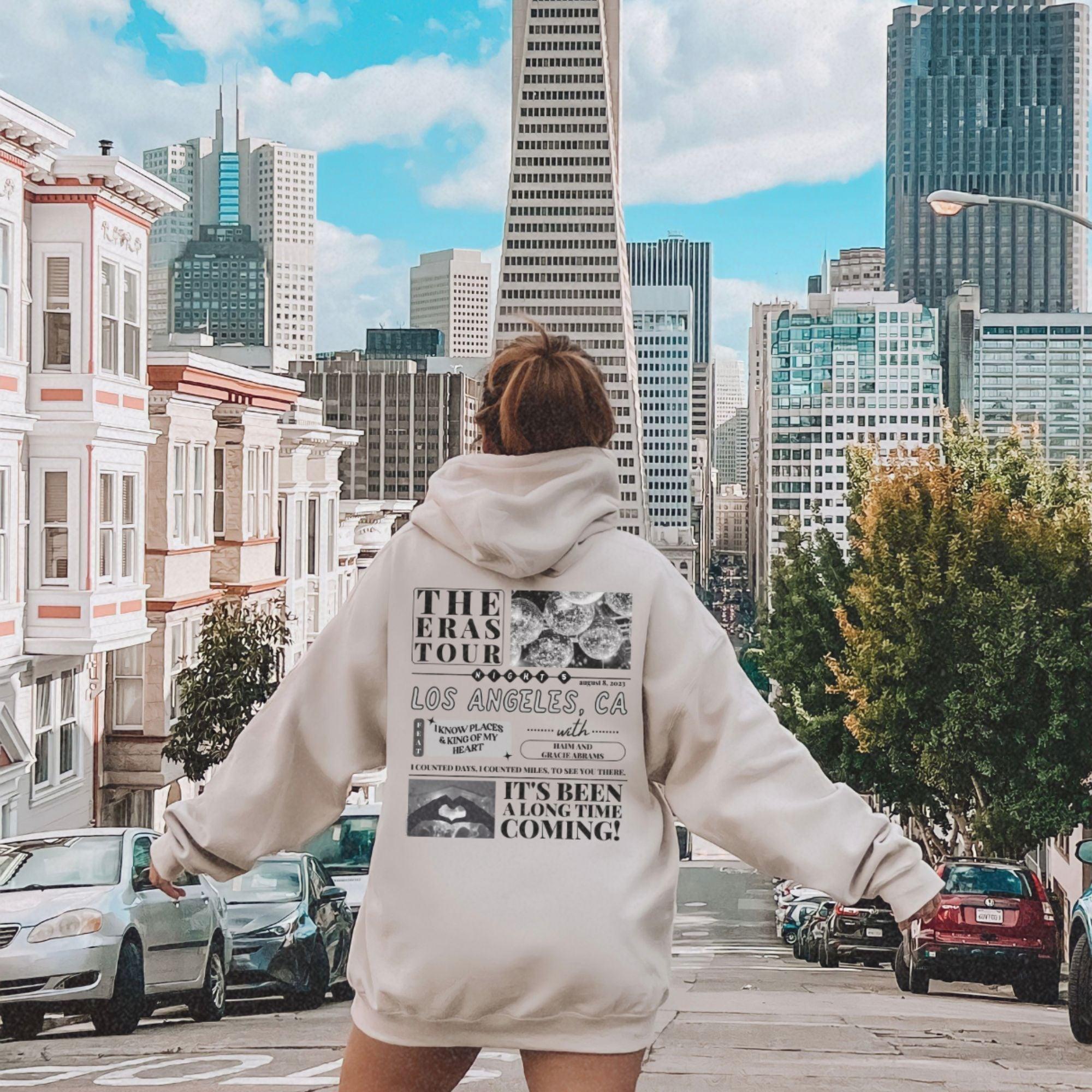a woman riding a skateboard down a city street
