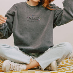 a woman sitting on a bed with her hands in the air