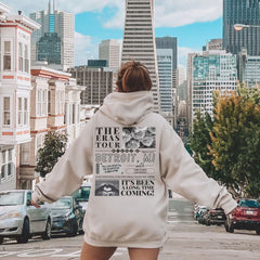 a woman riding a skateboard down a city street