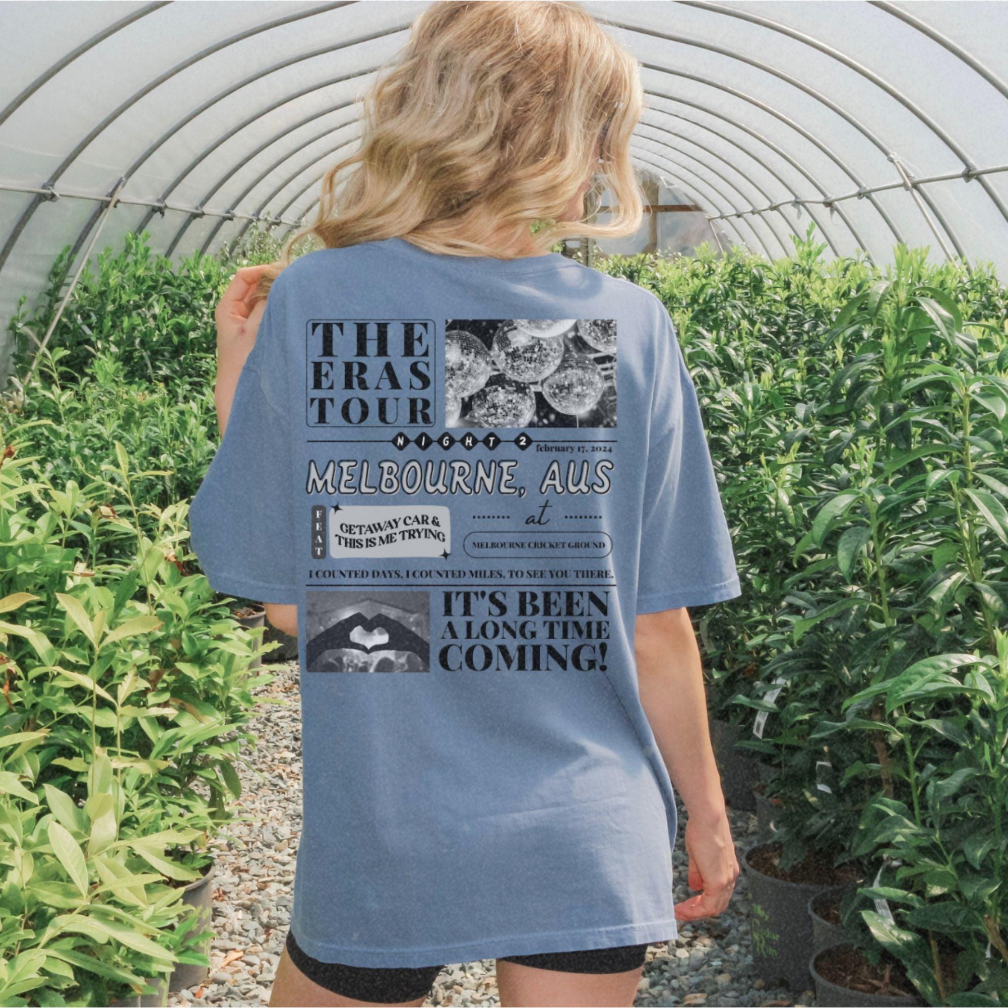 a woman standing in a greenhouse looking at plants