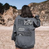 a woman standing in a field with her back to the camera