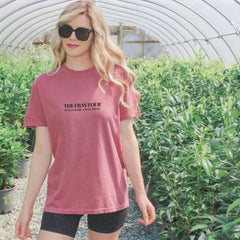 a woman wearing a pink shirt and black shorts