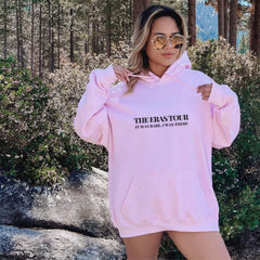 a woman wearing a pink sweatshirt and shorts