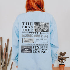 a woman with red hair wearing a blue sweatshirt