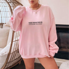 a woman wearing a pink sweatshirt and shorts