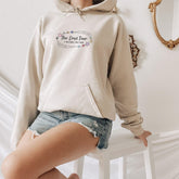 a woman in a white hoodie is posing for a picture