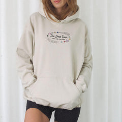 a woman wearing a white hoodie with the words the great four printed on it