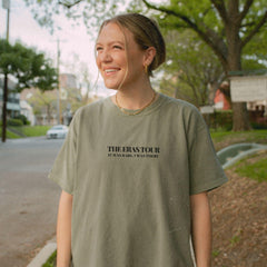a woman standing on the side of a road
