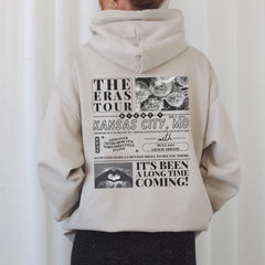 a person wearing a white hoodie with a black and white graphic on it