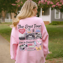 a woman wearing a pink sweatshirt with the words the eras tour on it