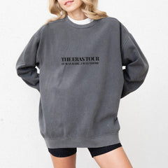 a woman wearing a sweatshirt with the words the erase tour printed on it
