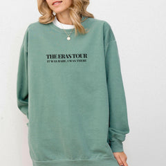 a woman wearing a green sweatshirt with black lettering