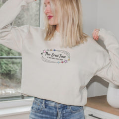 a woman wearing a sweatshirt with the words the bros tour on it