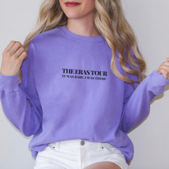 a woman wearing a purple sweatshirt with the words the perks tour on it