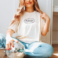 a woman sitting on the floor holding a disco ball