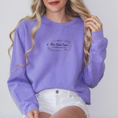 a woman wearing a purple sweatshirt and white shorts