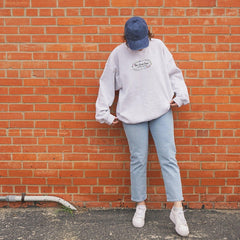 a person standing against a brick wall
