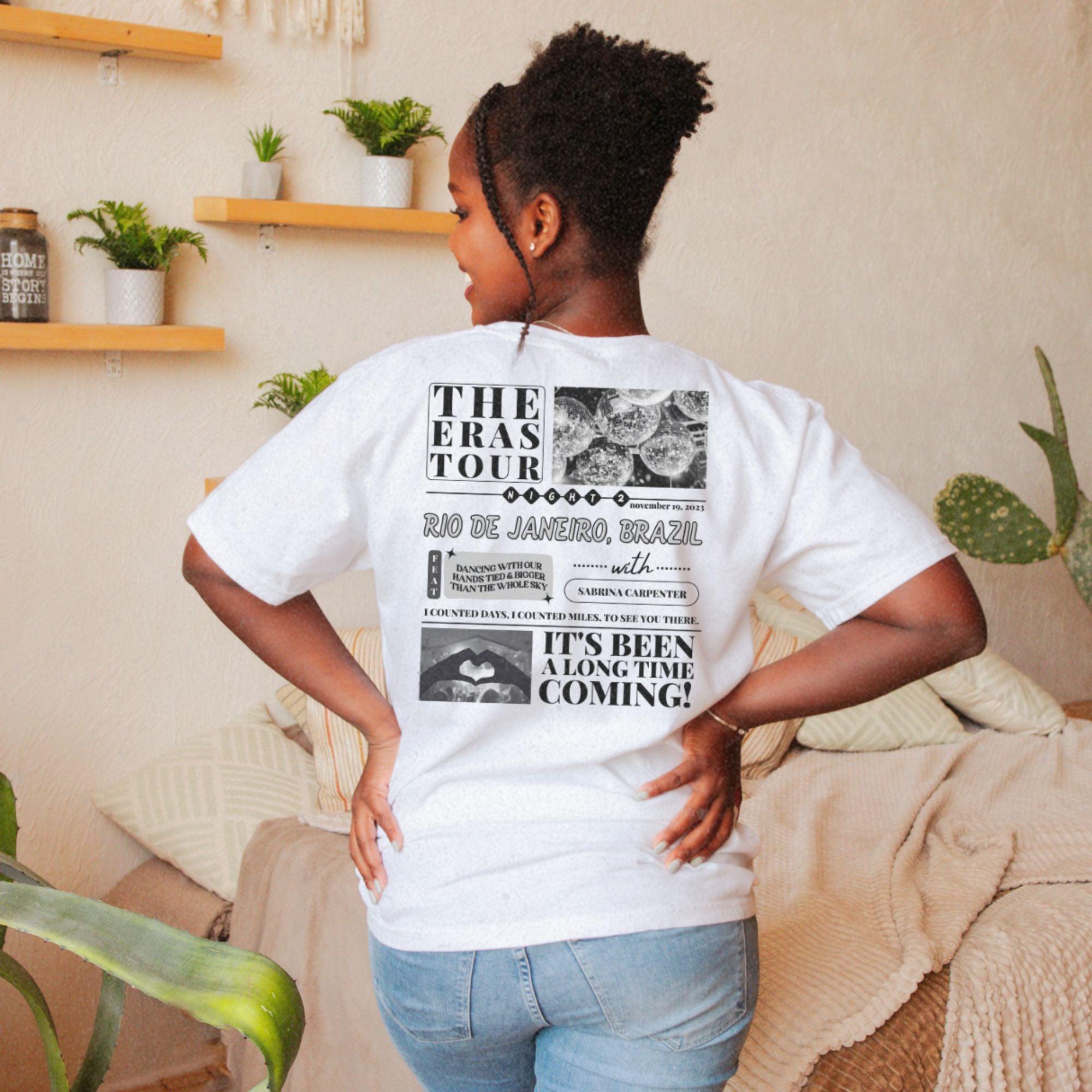 a woman in a white t - shirt is standing in a living room