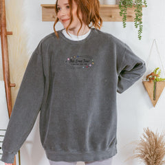 a woman standing in front of a wall with a plant