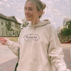 a woman in a white hoodie is holding a frisbee
