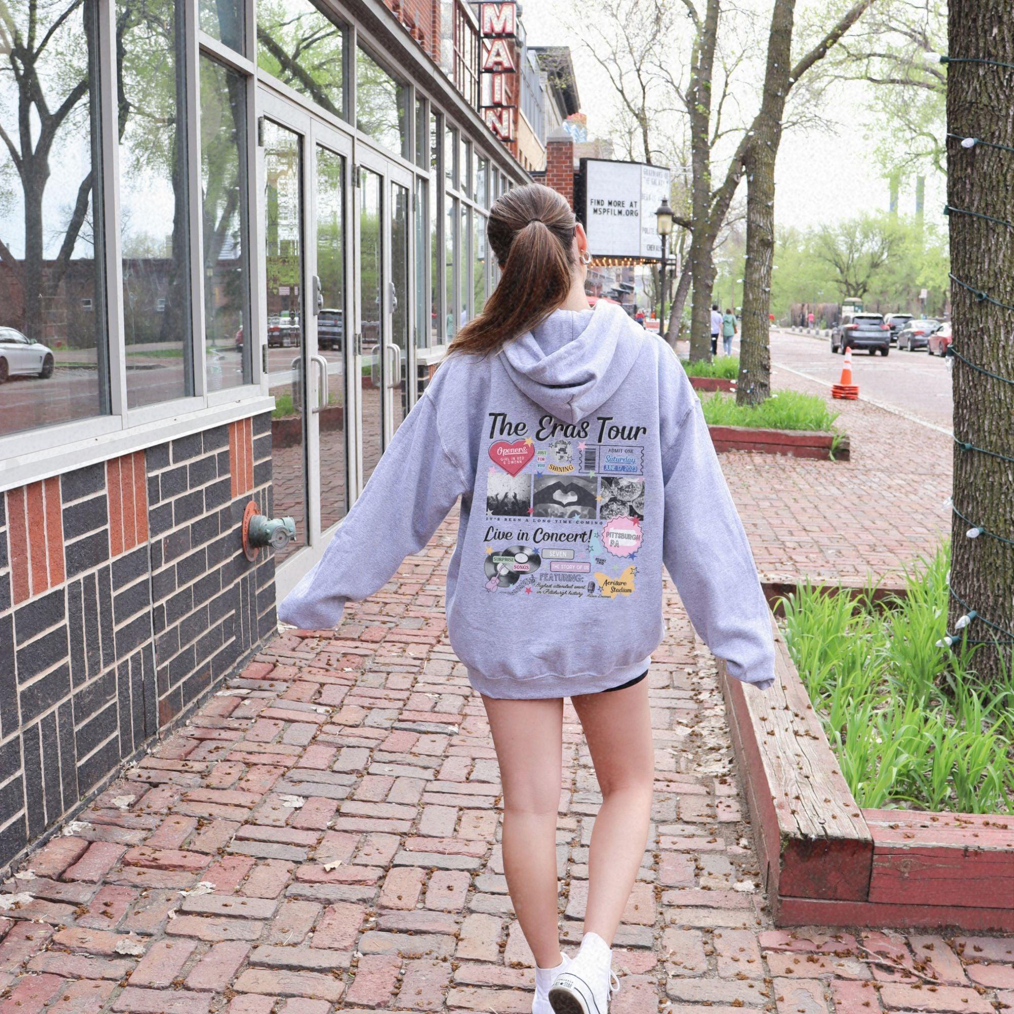 a woman is walking down a brick sidewalk