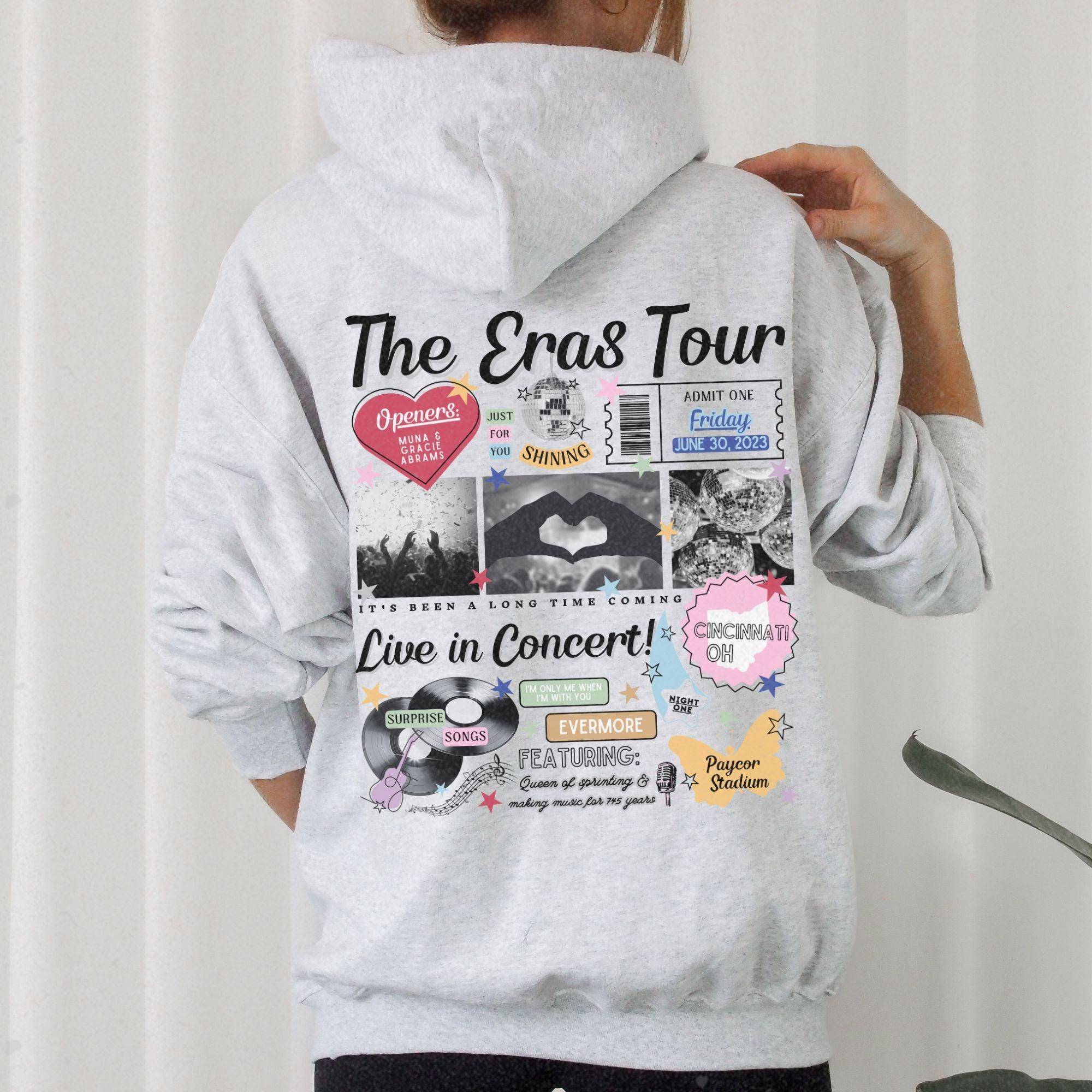 a person wearing a hoodie with a bunch of stickers on it