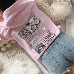 a pink shirt and jeans laying on a bed