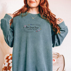 a woman with red hair wearing a blue sweatshirt