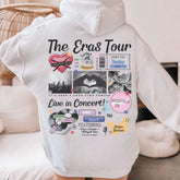 a person wearing a white hoodie with the words the eras tour on it