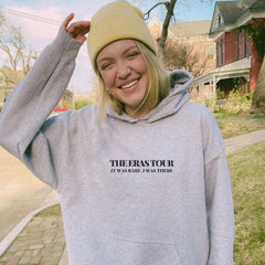 a woman wearing a grey sweatshirt and a yellow hat