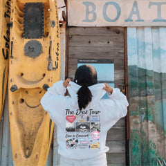a woman standing in front of a yellow boat