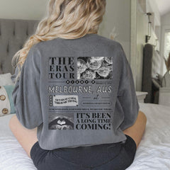 a woman sitting on a bed with her back to the camera