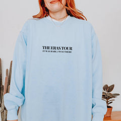 a woman with red hair wearing a blue sweatshirt