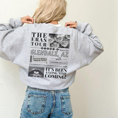 a woman wearing a grey sweatshirt with a bunch of pictures on it
