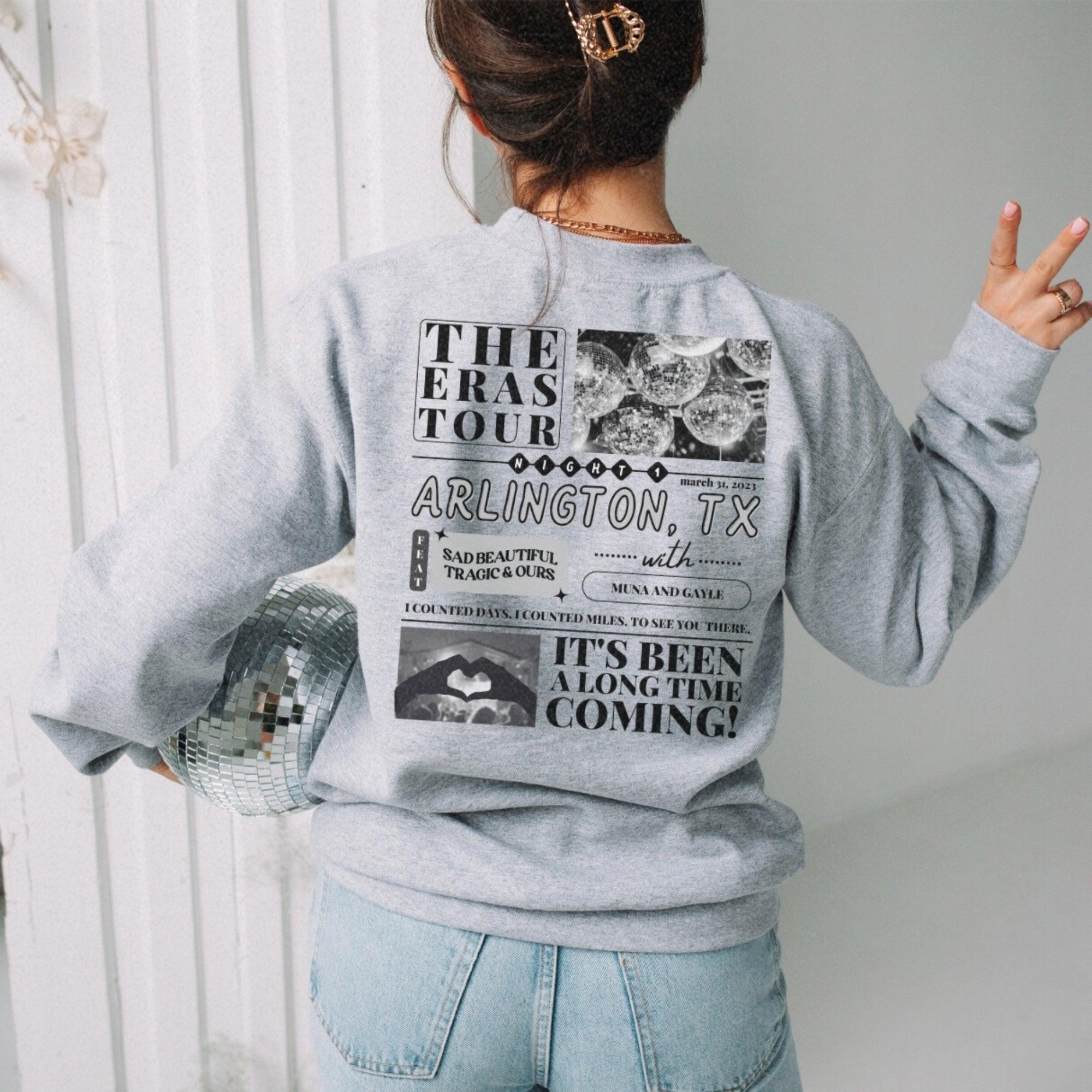 a woman wearing a gray sweatshirt and jeans