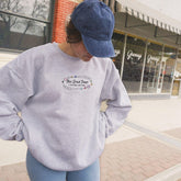 a woman in a blue hat is standing on a skateboard