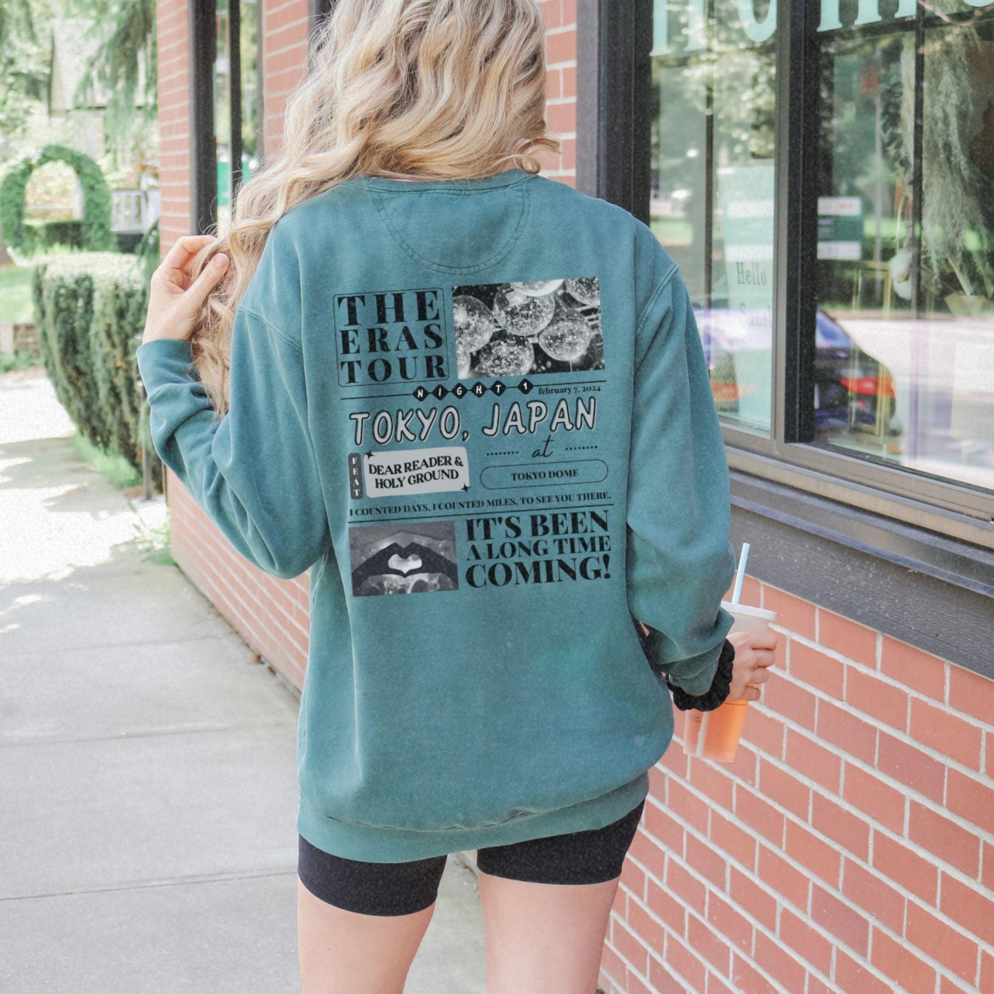 a woman standing outside of a building with her back to the camera