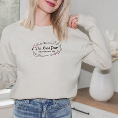 a woman in a white sweatshirt is posing for a picture