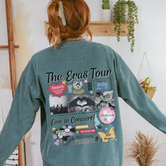 a woman in a blue sweatshirt with the words the saga tour on it