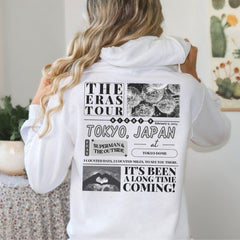 a woman wearing a white hoodie with the words tokyo japan printed on it