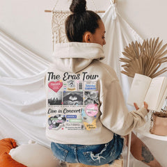 a woman sitting on a stool reading a book