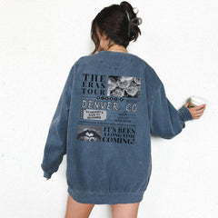 a woman standing against a wall holding a cup of coffee