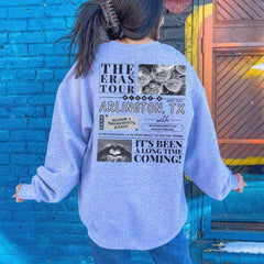 a woman standing in front of a blue brick wall