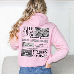 a woman wearing a pink hoodie with the words the erase tour on it
