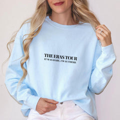a woman wearing a blue sweatshirt with the words the perkstour on it
