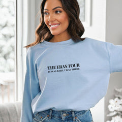 a woman wearing a blue sweatshirt and jeans