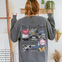 a woman wearing a grey sweatshirt with the words the cross tour printed on it