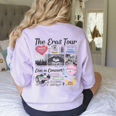 a woman sitting on top of a bed wearing a sweatshirt